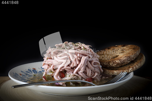 Image of typical sausage salad with bread