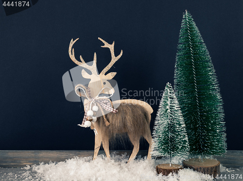 Image of Christmas decoration wooden reindeer with fir trees