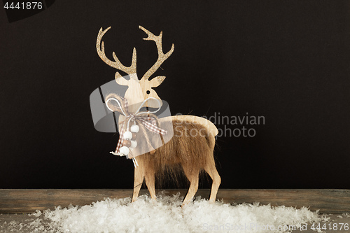 Image of Christmas decoration wooden reindeer in snow