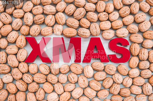 Image of Walnuts surrounding the word Xmas written in red letters