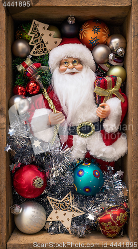 Image of Santa Claus doll in a wooden box with Christmas decoration