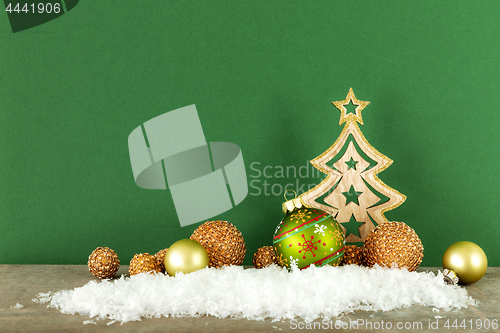 Image of Christmas decoration green background with wooden tree glass bal