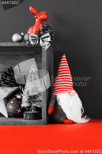 Image of Christmas decoration deer figure and gnome in a wooden box backg