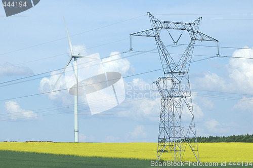 Image of A electric pylon near windturbine