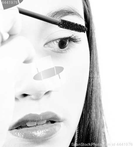 Image of Young Girl Applying Mascara To Her Eyelashes