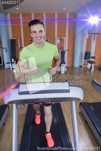 Image of sportsman exercise jogging on treadmill