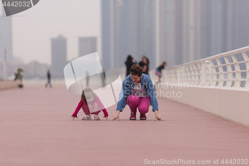 Image of mother and cute little girl on the promenade