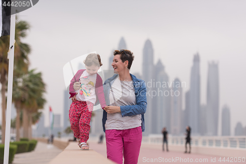 Image of mother and cute little girl on the promenade