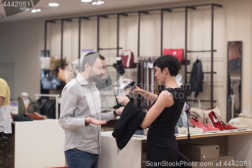 Image of couple chooses shoes At Shoe Store