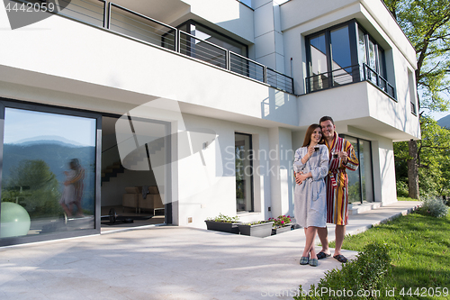 Image of Young beautiful couple in bathrobes