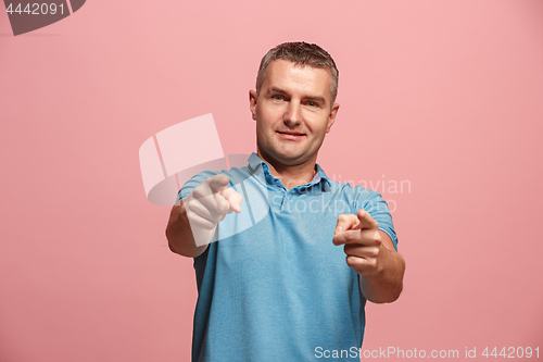Image of The happy business man point you and want you, half length closeup portrait on pink background.