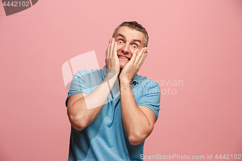 Image of Portrait of the scared man on pink