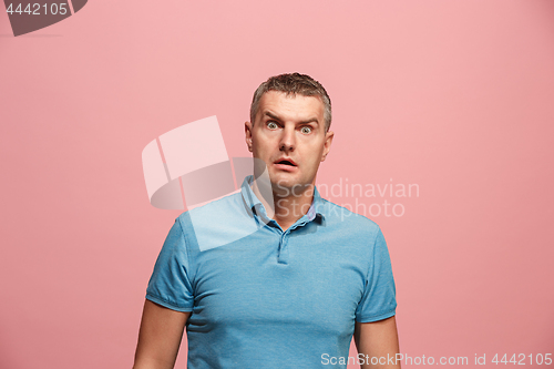 Image of Portrait of the scared man on pink