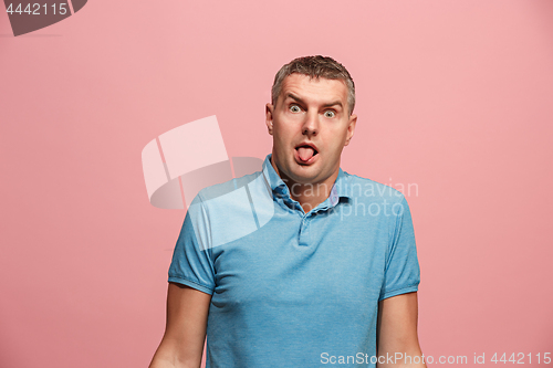 Image of The squint eyed man with weird expression isolated on pink