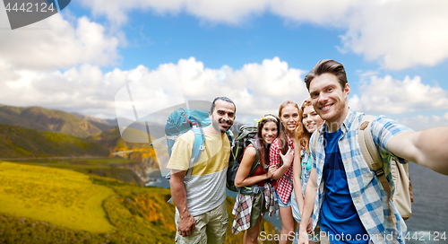 Image of friends with backpacks taking selfie