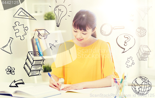 Image of happy asian young woman student learning at home