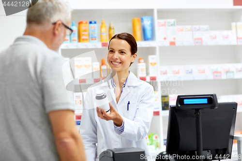 Image of apothecary and senior customer at pharmacy
