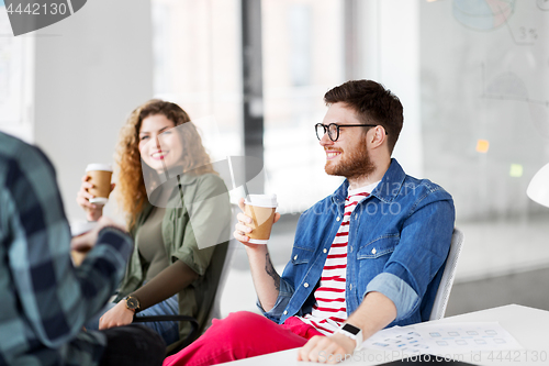 Image of creative team drinking coffee at office