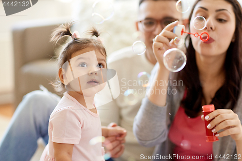 Image of family with soap bubbles playing at home