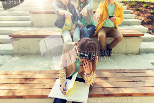 Image of student girl suffering of classmates mockery