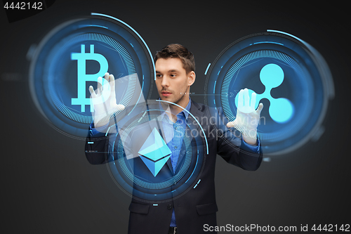 Image of businessman with cryptocurrency holograms