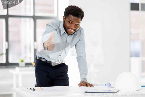 Image of african architect with blueprint showing thumbs up