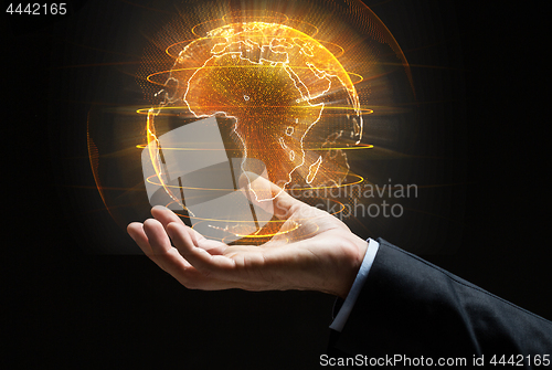 Image of close up of businessman hand with earth hologram