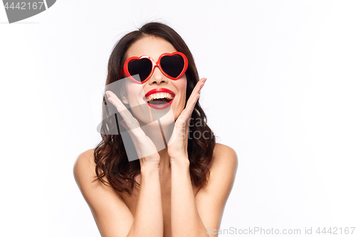 Image of woman with red lipstick and heart shaped shades