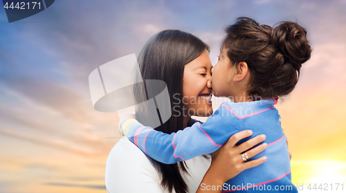 Image of happy mother and daughter hugging and kissing