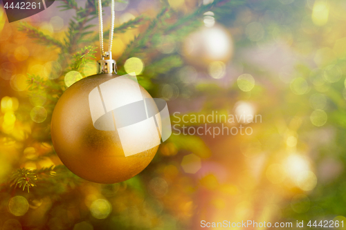 Image of Christmas-tree decoration bauble on decorated Christmas tree bac