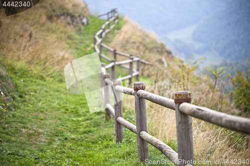 Image of Italian landscape, hills and wooden handrails.