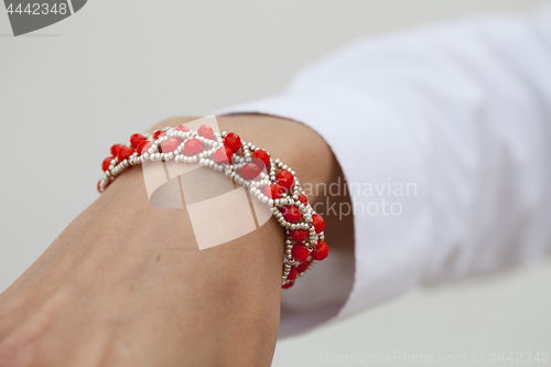 Image of Stylish red bead bracelet on female hand