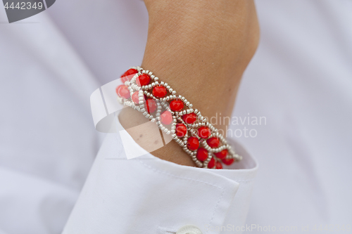 Image of Stylish red bead bracelet on female hand 