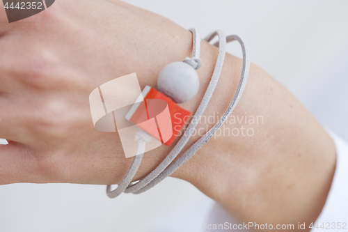 Image of Stylish red and grey bead bracelet on female hand