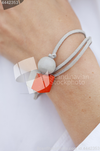 Image of Stylish red and grey bead bracelet on female hand