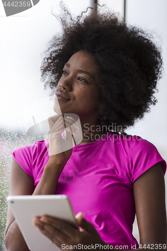 Image of african american woman using tablet