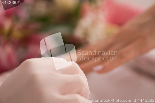 Image of Woman hands receiving a manicure