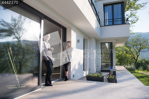 Image of couple enjoying on the door of their luxury home villa