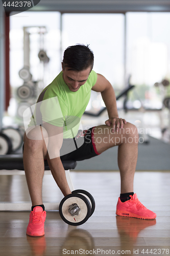 Image of handsome man working out with dumbbells