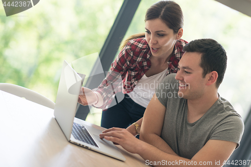 Image of happy young couple buying online