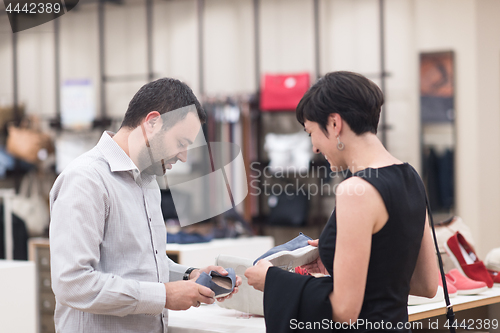 Image of couple chooses shoes At Shoe Store