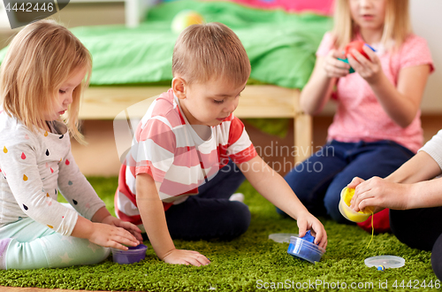 Image of kids and mother with modelling clay or slimes