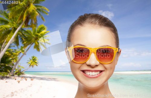 Image of happy woman or teenage girl in sunglasses on beach