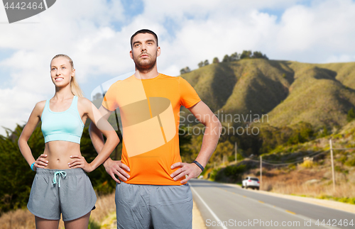 Image of happy couple doing sports over big sur hills