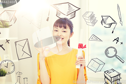 Image of happy asian woman student with diploma at home