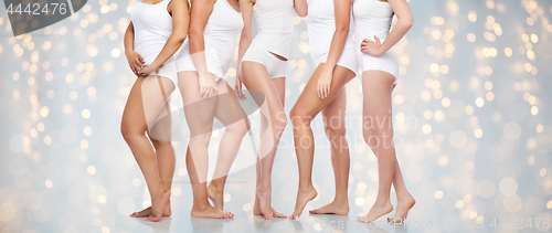 Image of group of happy diverse women in white underwear