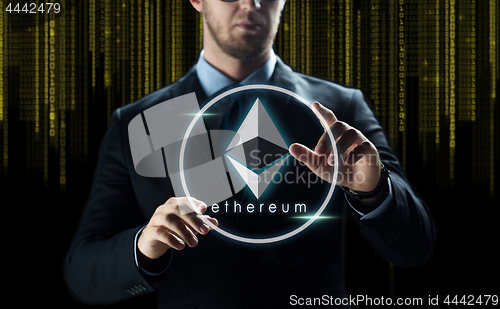 Image of businessman with ethereum over binary code