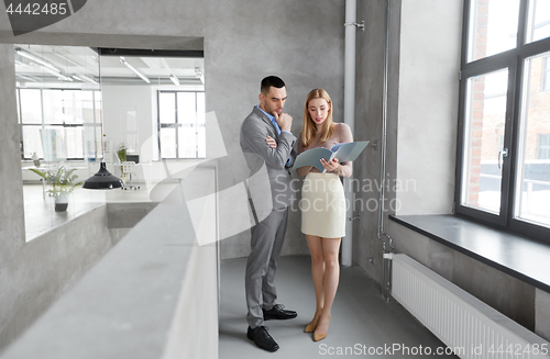 Image of businesswoman and businessman with folder