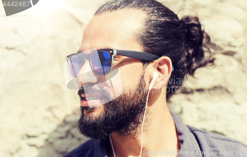 Image of happy man with earphones listening to music