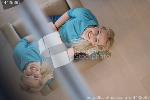 Image of Young woman using laptop at home top view